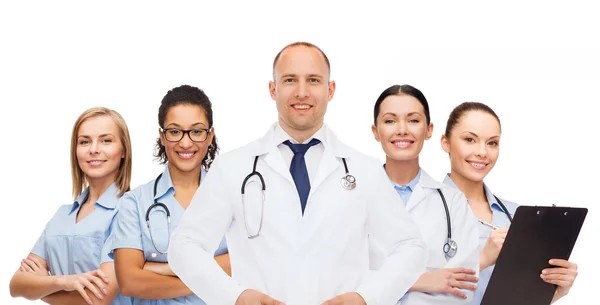 Group of smiling doctors with clipboard — Stock Photo, Image