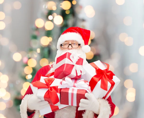 Man in kostuum van de kerstman met geschenkdozen — Stockfoto