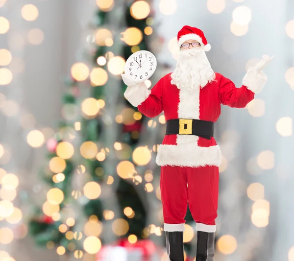 Man in costume of santa claus with clock — Stock Photo, Image