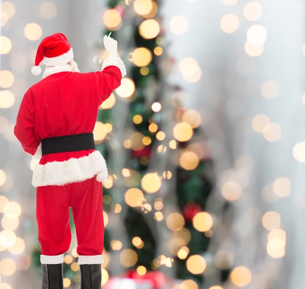 Mannen i kostym jultomten skriva något — Stockfoto