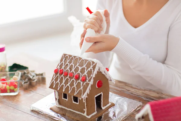 Close up of woman making gingerbread house at home — Stock Photo, Image