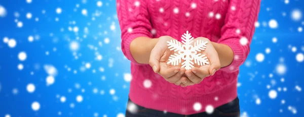Close up of woman holding snowflake decoration Royalty Free Stock Images