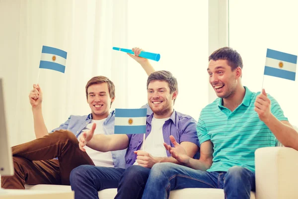 Happy male friends with flags and vuvuzela — Stock Photo, Image