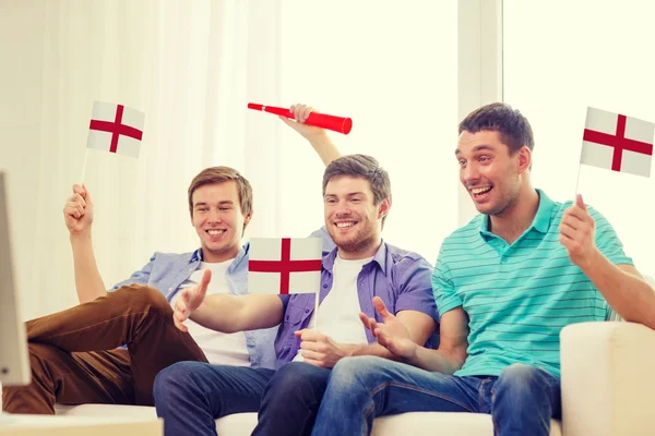 Happy male friends with flags and vuvuzela — Stock Photo, Image