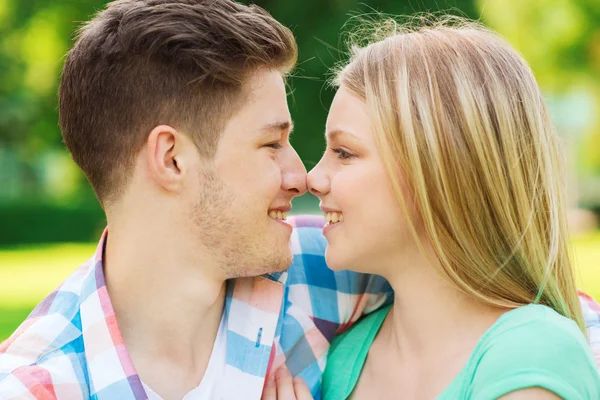 Smiling couple touching noses in park Stock Photo