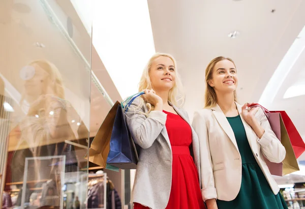 Genç kadınlarla mutlu alışveriş merkezinde alışveriş torbaları — Stok fotoğraf