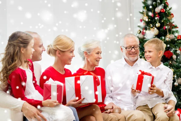 Smiling family with gifts at home — Stock Photo, Image