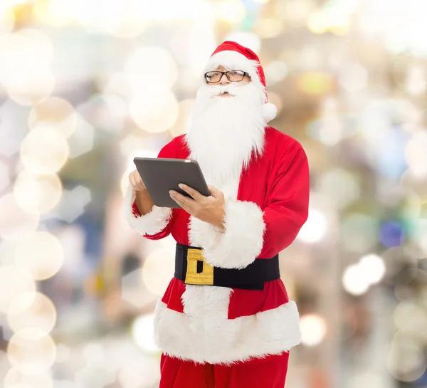 Man in costume of santa claus with tablet pc — Stock Photo, Image