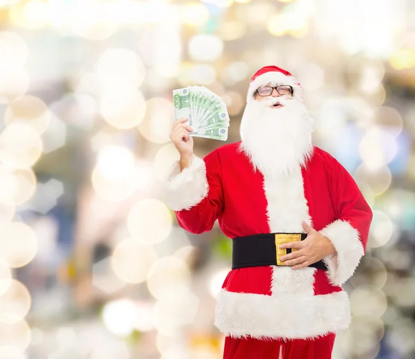 Mann im Weihnachtsmannkostüm mit Eurogeld — Stockfoto