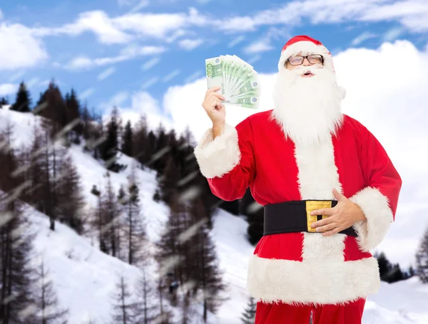 Man in kostuum van de kerstman met euro geld — Stockfoto