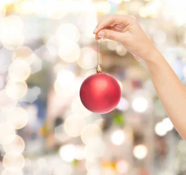 Close up of woman in sweater with christmas ball — Stock Photo, Image