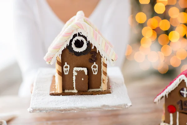 Kadın gösteren gingerbread evi yakın çekim — Stok fotoğraf