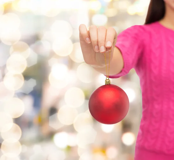 Close up of woman in sweater with christmas ball — Stock Photo, Image