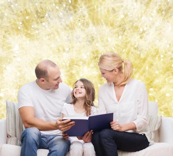 Happy family with book at home — Stock Photo, Image