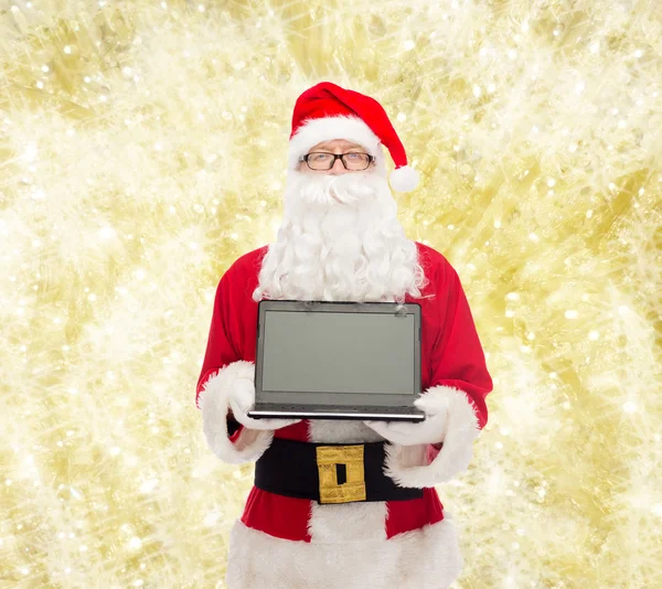 Man in costume of santa claus with laptop — Stock Photo, Image