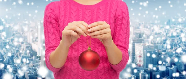 Close up of woman in sweater with christmas ball — Stock Photo, Image