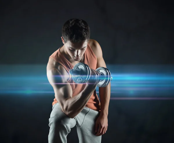 Young man with dumbbell flexing biceps — Stock Photo, Image