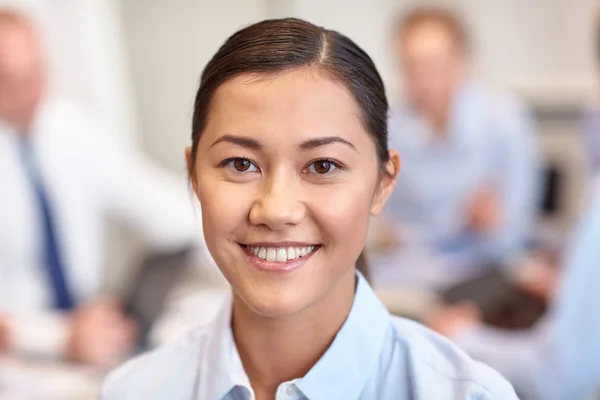 Group of smiling businesspeople meeting in office — Stock Photo, Image