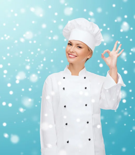 Smiling female chef showing ok hand sign — Stock Photo, Image