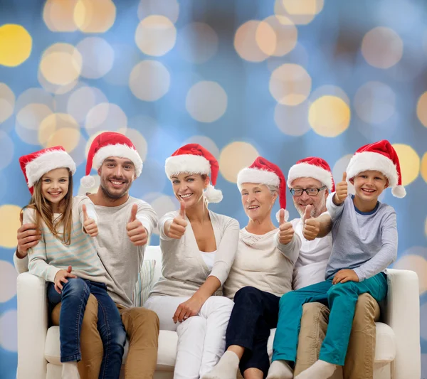 Happy family sitting on couch — Stock Photo, Image