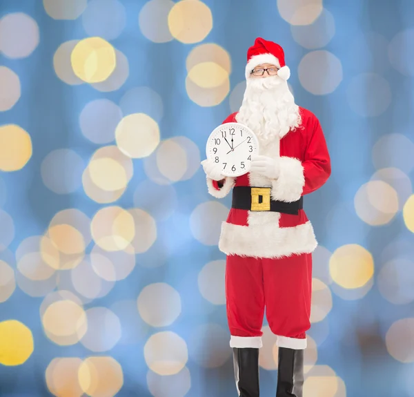 Man in costume of santa claus with clock — Stock Photo, Image