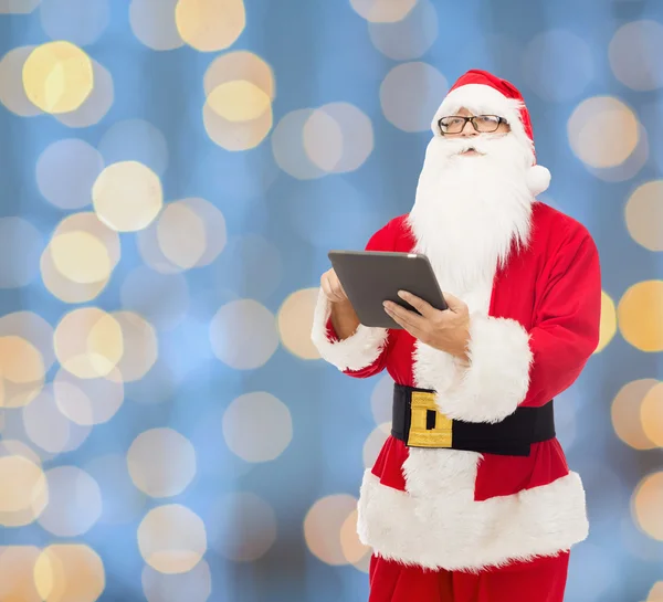 Man in costume of santa claus with tablet pc — Stock Photo, Image