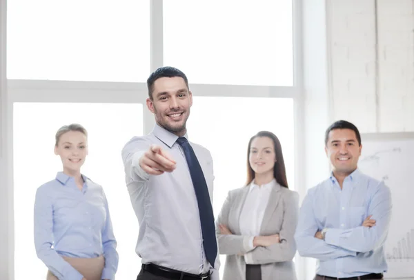 Businessman in office pointing finger at you — Stock Photo, Image