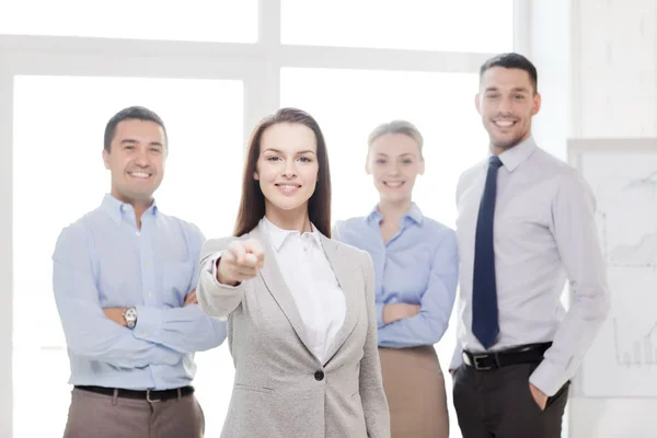 Businesswoman in office pointing finger at you — Stock Photo, Image