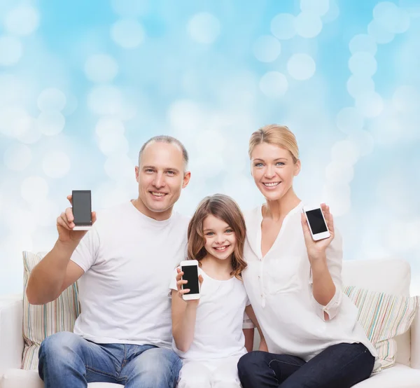 Happy family with smartphones — Stock Photo, Image