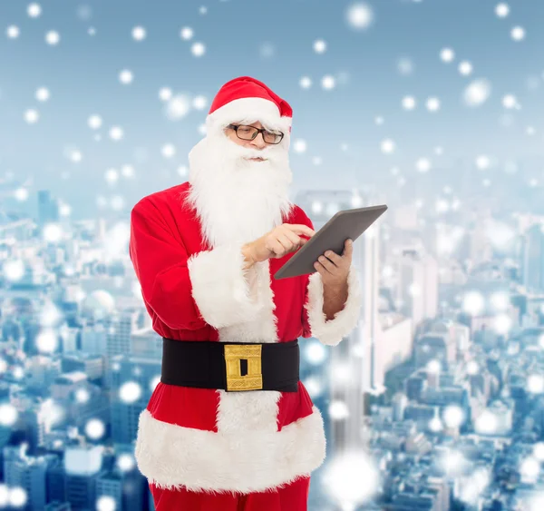 Man in costume of santa claus with tablet pc — Stock Photo, Image