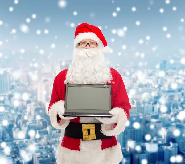 Man in costume of santa claus with laptop — Stock Photo, Image