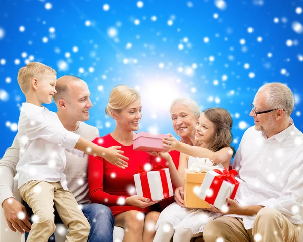 Smiling family with gifts — Stock Photo, Image