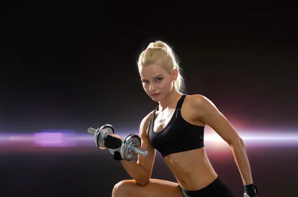 Young sporty woman with heavy steel dumbbell — Stock Photo, Image
