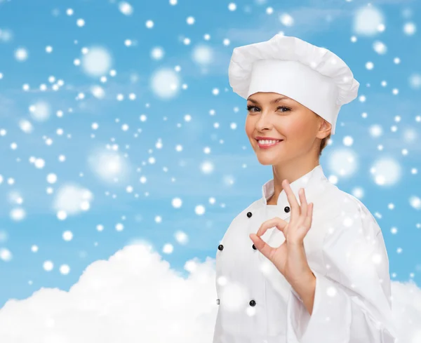 Smiling female chef showing ok hand sign — Stock Photo, Image