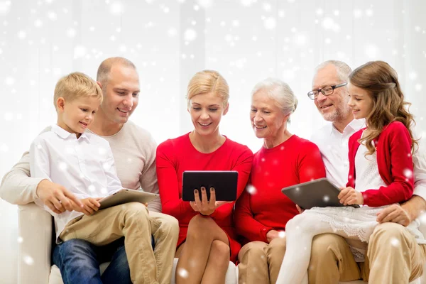 Smiling family with tablet pc computers at home — Stock Photo, Image