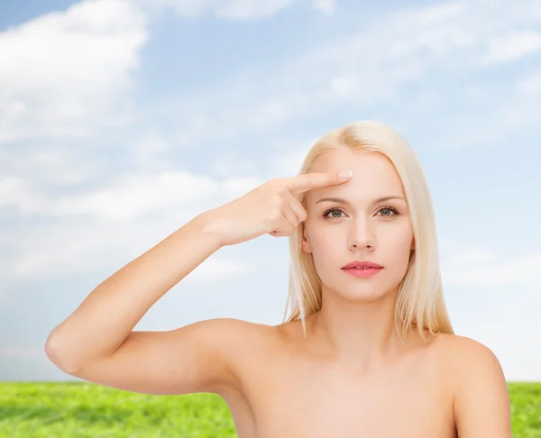 Beautiful woman touching her forehead — Stock Photo, Image