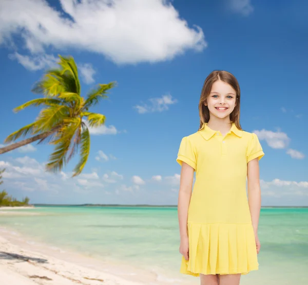 Smiling little girl in yellow dress — Stock Photo, Image