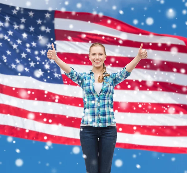 Smiling girl in casual clothes showing thumbs up — Stock Photo, Image