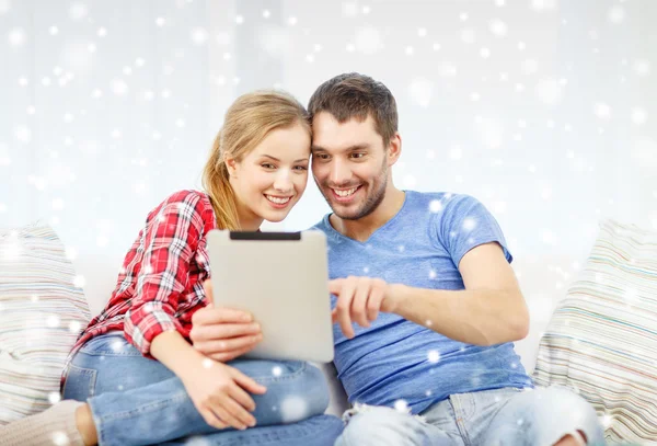 Smiling couple with tablet pc computer at home — Stock Photo, Image