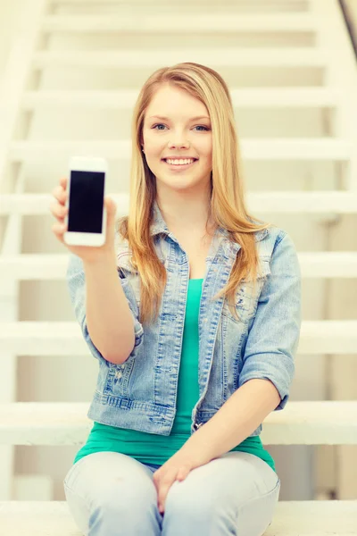 Улыбающийся студент с пустым экраном на смартфоне — стоковое фото