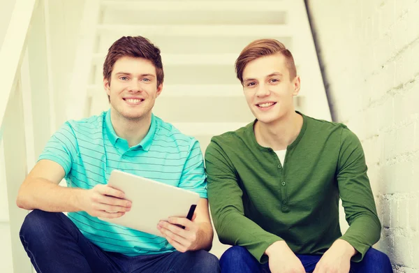 Smiling male students with tablet pc computer — Stock Photo, Image