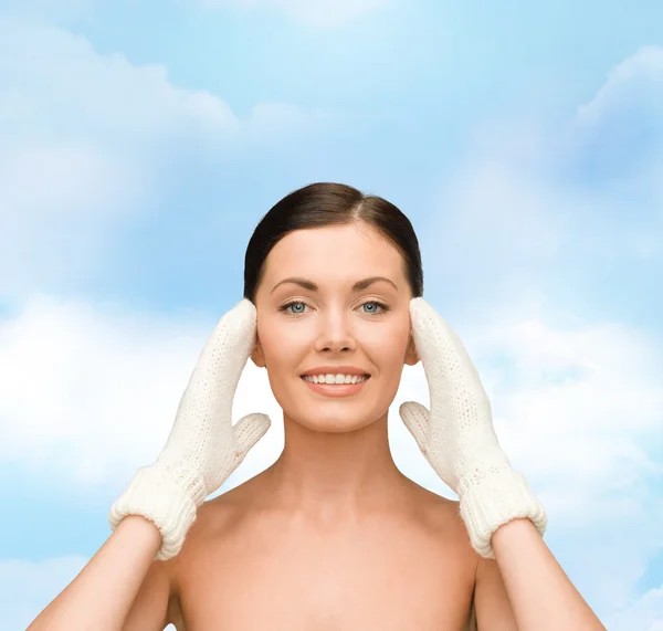 Smiling young woman in white mittens — Stock Photo, Image