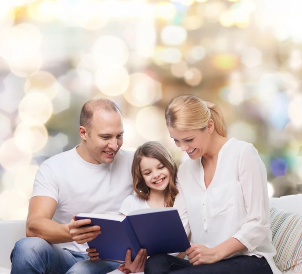 Famiglia felice con libro a casa — Foto Stock