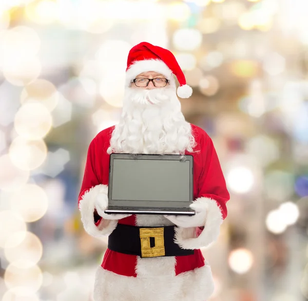 Man in costume of santa claus with laptop — Stock Photo, Image