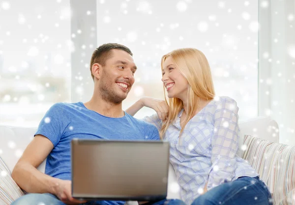 Smiling happy couple with laptop at home — Stock Photo, Image