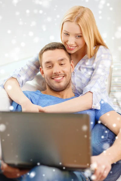 Smiling happy couple with laptop at home — Stock Photo, Image