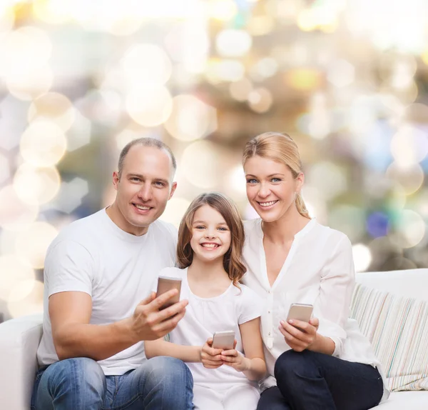 Happy family with smartphones — Stock Photo, Image