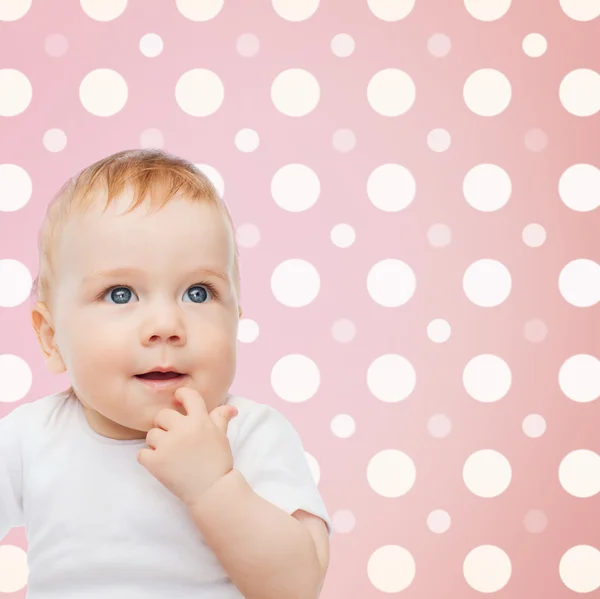 Sorridente bebê menina rosto sobre rosa bolinhas — Fotografia de Stock