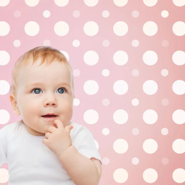 Sonriente cara de niña sobre lunares rosados — Foto de Stock