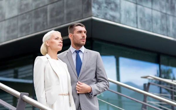Serious businessmen standing over office building — Stock Photo, Image